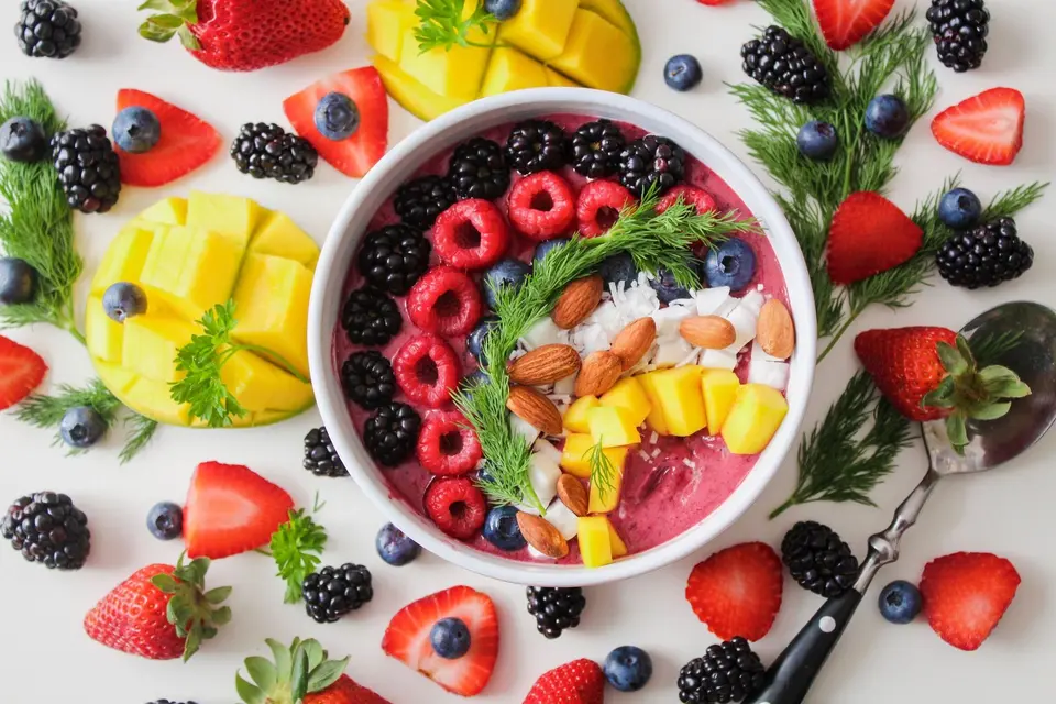 Glass bowl of strawberries, blueberries, and mango