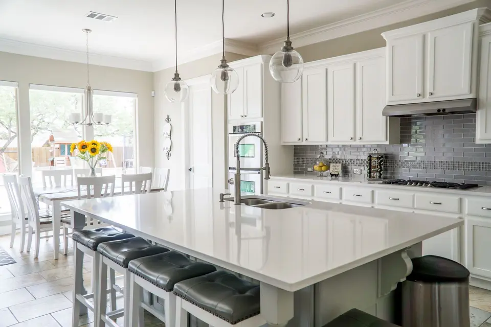 Bright white kitchen with a wooden island