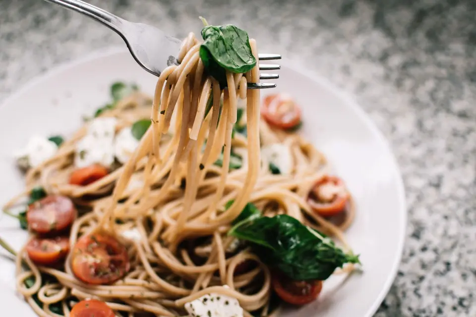 Bowl of pasta with tomato sauce and basil