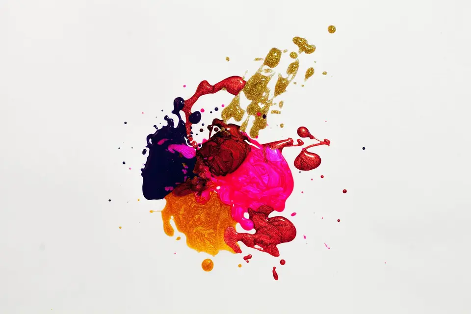 Splash of blue, yellow, and red paint on white